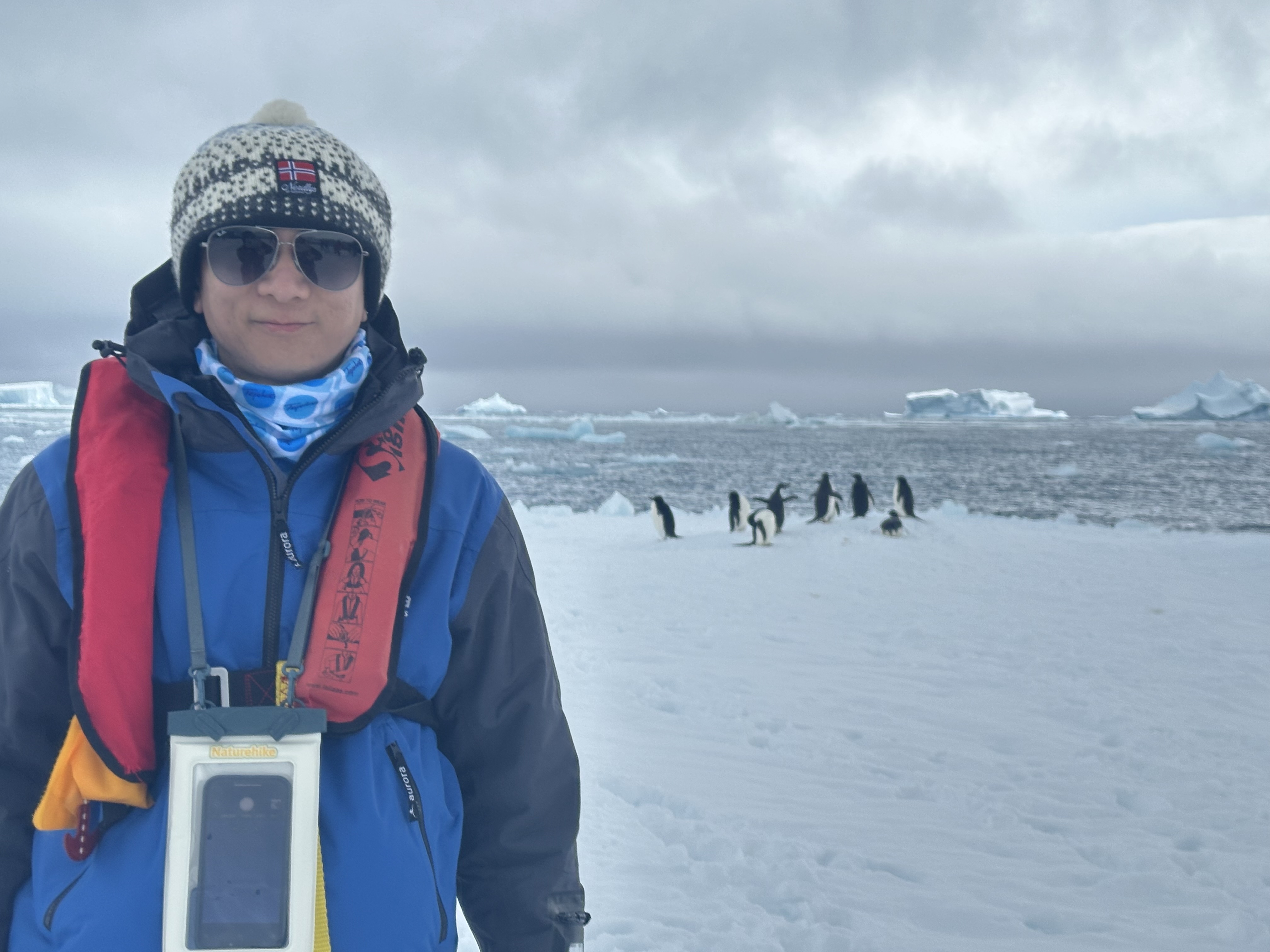 Steven completing the seventh continent with a penguin